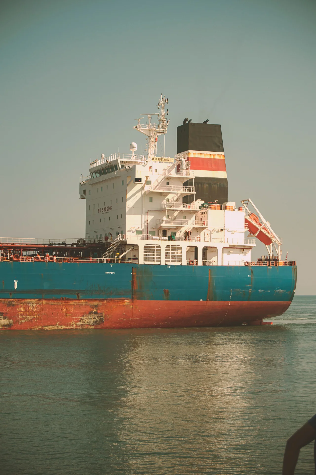 Cargo vessel superstructure and hull in the soft light of late afternoon
